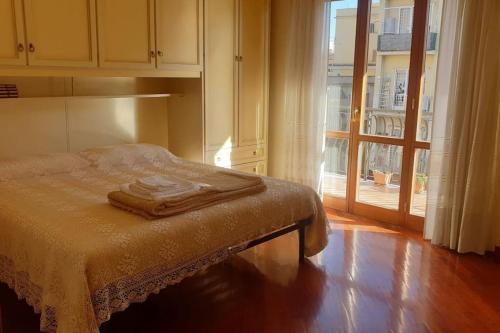 a bedroom with a bed and a sliding glass door at GUALANDI 25 in Rome