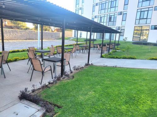 a group of tables and chairs under a pavilion at Condo PH Lago Luna, Chante in Chantepec