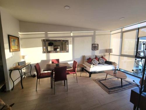 a living room with a couch and a table at Condo PH Lago Luna, Chante in Chantepec