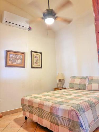 a bedroom with a bed and a ceiling fan at Seville Suite in San Juan del Sur
