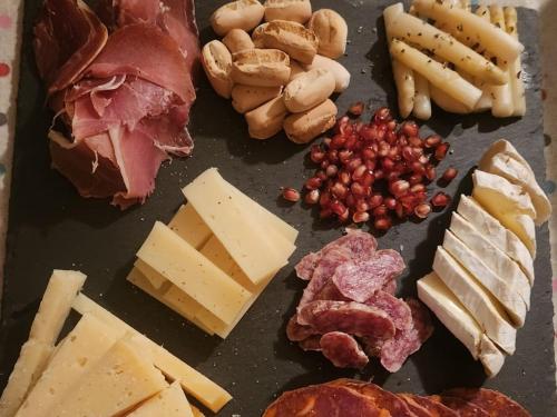 a bunch of different types of cheese and meats at Casa Tadeguaz in Fago