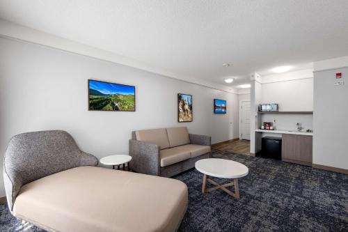 a living room with a couch and a chair at SureStay Plus Hotel by Best Western Billings in Billings