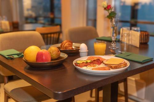 a table with a plate of food and fruit on it at Sirdalsvatnet Hotel in Sirdal in Tonstad