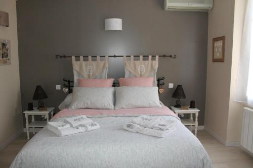 a bedroom with a bed with two towels on it at Lou Bastido in Marseille