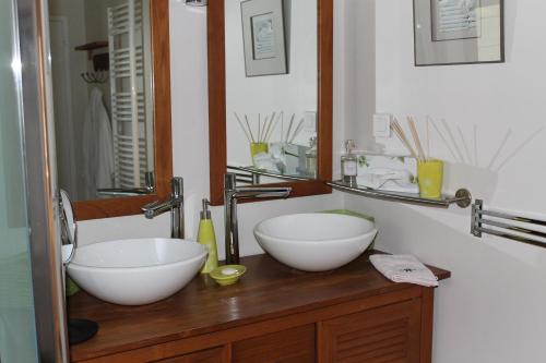 a bathroom with two white bowls on a wooden counter at Lou Bastido in Marseille