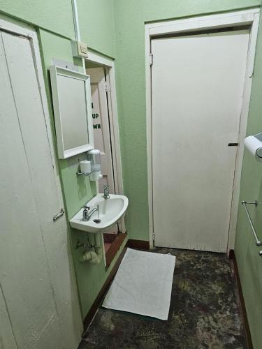a bathroom with a sink and a mirror at Cholson Chalets in Charlotteville