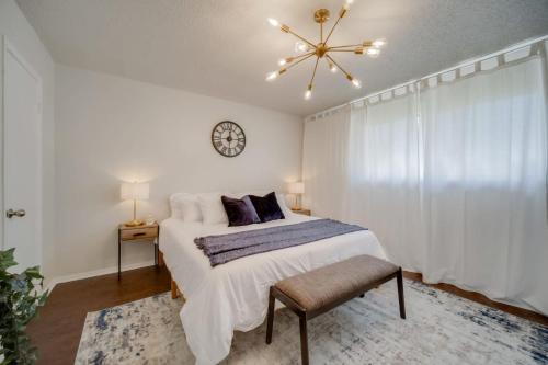 a bedroom with a bed and a clock on the wall at Stunning 4BR 2BA Hot Tub Cozy Holiday Home in Plano in Plano