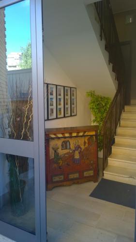 a hallway with a staircase with a painting on the wall at Almi Rooms in Rome