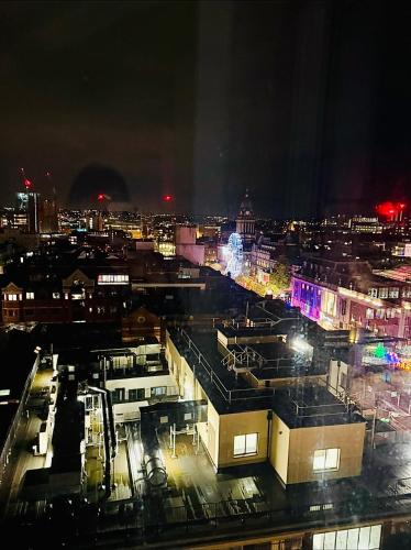 a view of a city at night with lights at Winners of 2025 traveller Award, Elegant two bedroom city central apartment with Netflix & WiFi in Leeds