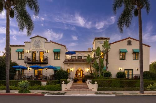 a house with palm trees in front of it at The Eagle Inn in Santa Barbara