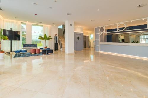 a large lobby with a large tile floor at Hotel Puerta Santander in Santander
