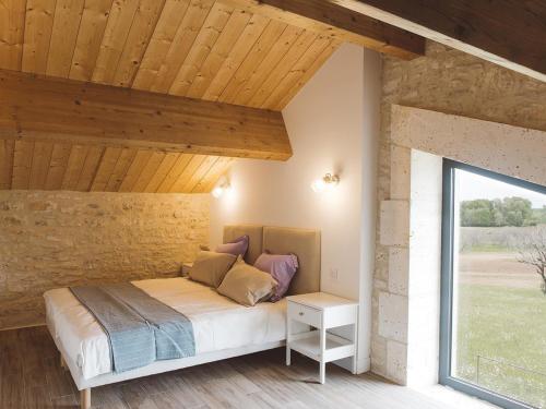 a bedroom with a bed and a large window at Maison climatisée avec terrasse et Wi-Fi, animaux admis, proche Périgord Vert - FR-1-616-391 in Sorges