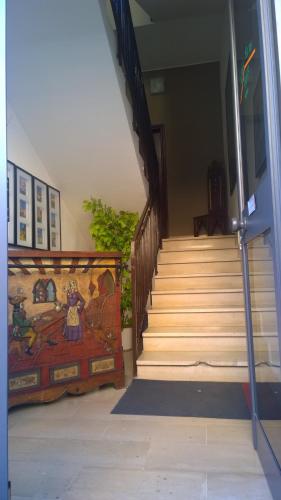 a staircase in a building with a painting on the wall at Almi Rooms in Rome