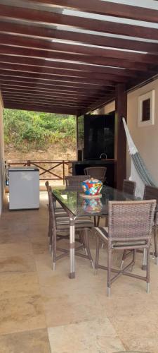 a dining table and chairs on a patio at Chalé Serrano in Guaramiranga