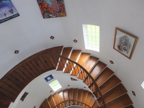an overhead view of a spiral staircase with paintings at Tanamera Estate Weligama in Weligama