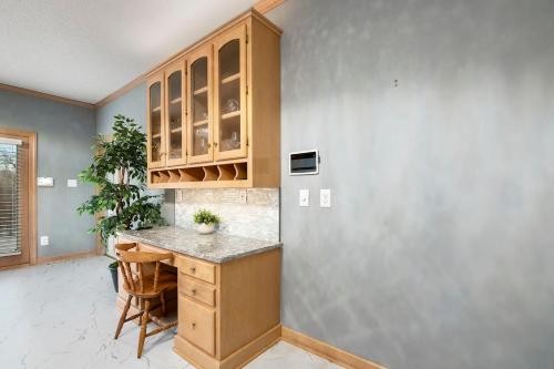 a kitchen with wooden cabinets and a counter top at Whisper Chateau Weddings Reunions Groups 75 Plus in Greensboro
