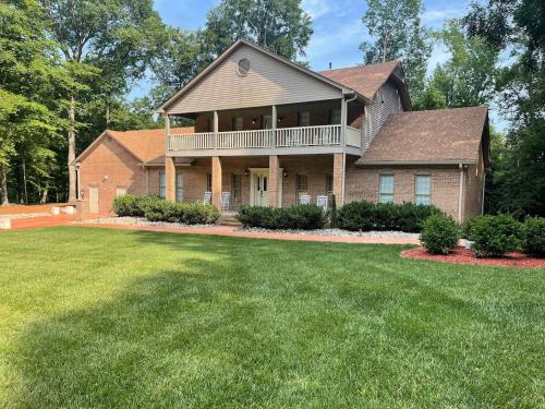 a house with a large yard in front of it at Whisper Chateau Weddings Reunions Groups 75 Plus in Greensboro