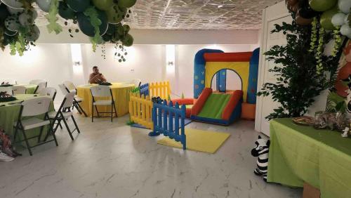 a room with a play room with a table and chairs at Whisper Chateau Weddings Reunions Groups 75 Plus in Greensboro
