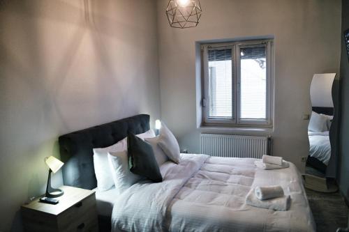 a bedroom with a large bed and a window at Maison du Lac in Kastoria