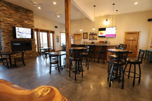 a restaurant with tables and chairs and a bar at Lakeside Resort in Watkins Glen