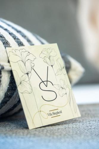 a card that is sitting on top of a towel at Villa Shepherd Zanzibar - LUXURY BEACH FRONT - KIWENGWA in Kumba Urembo