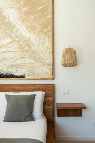a bedroom with a bed and a painting on the wall at Villa Shepherd Zanzibar - LUXURY BEACH FRONT - KIWENGWA in Kumba Urembo