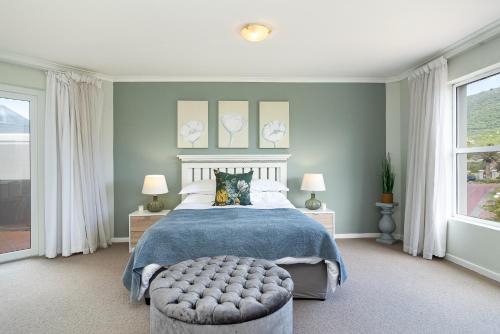a bedroom with a bed and a large window at Beachfront Villa Sea Breeze Hout Bay Cape Town in Hout Bay