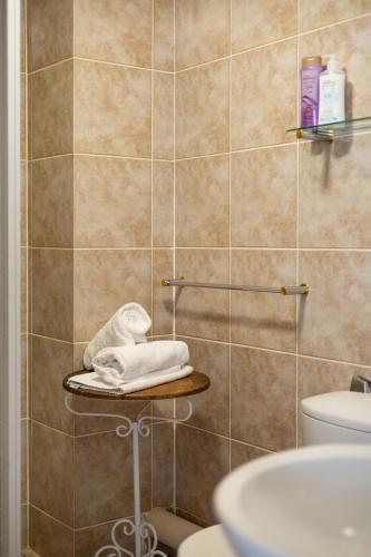 a bathroom with a shower with a towel on a shelf at Beachfront Villa Sea Breeze Hout Bay Cape Town in Hout Bay
