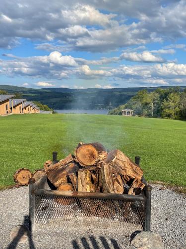 a pile of logs sitting next to a field at Lakeside Resort in Watkins Glen