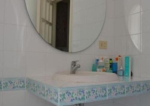 a bathroom with a sink and a mirror at Villa Gioia in Ischia