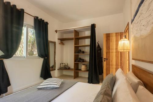 a bedroom with a bed and a window at Villa Shepherd Zanzibar - LUXURY BEACH FRONT - KIWENGWA in Kumba Urembo