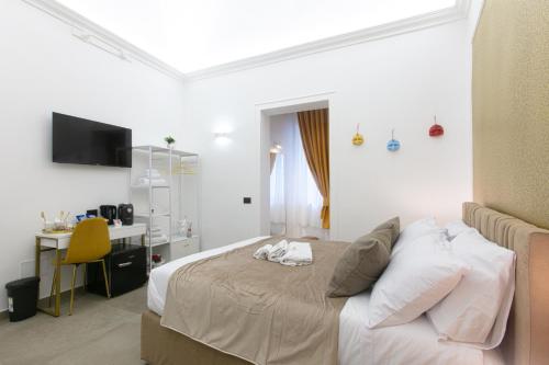 a bedroom with a bed and a desk at Pignasecca Domus in Naples