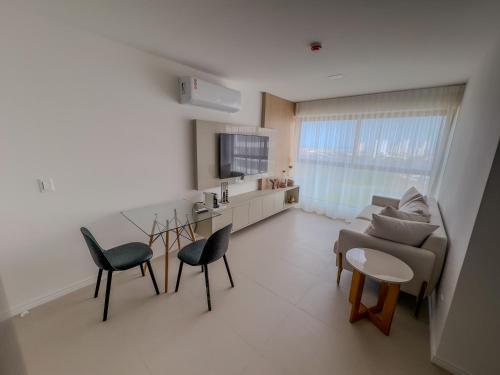ein Wohnzimmer mit einer Couch und einem Tisch und Stühlen in der Unterkunft Apartamento em Recife, condomínio de luxo in Recife