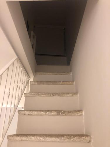 a staircase in a house with white stairs at Netium B&B in Andria