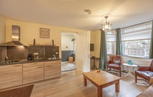 a kitchen with a table and a living room at Luxe Appartementen Leonardus in Valkenburg