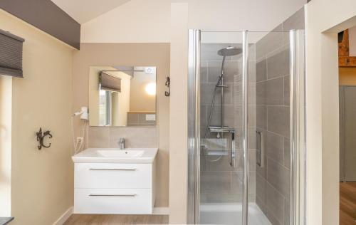a bathroom with a sink and a glass shower at Luxe Appartementen Leonardus in Valkenburg