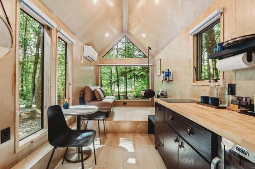 a kitchen and living room in a tiny house at Lumen Nature Retreat in Woodstock