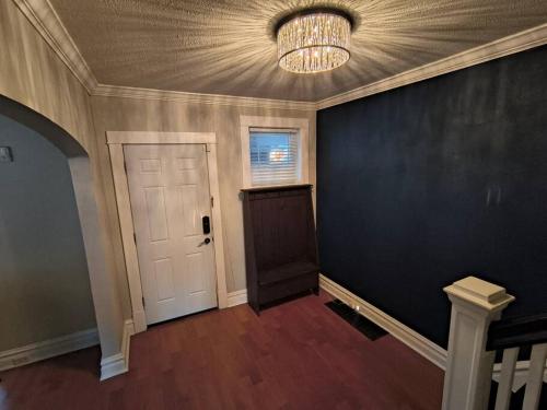 an empty room with a door and a chandelier at 2 story nice home with character in Saint Louis