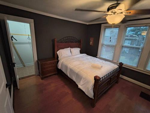 a bedroom with a bed and a ceiling fan at 2 story nice home with character in Saint Louis