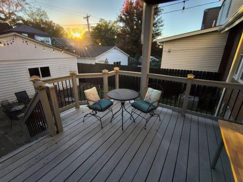 a patio with a table and chairs on a deck at 2 story nice home with character in Saint Louis