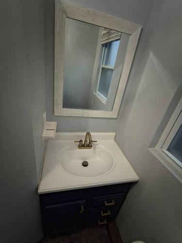 a bathroom with a sink and a mirror at 2 story nice home with character in Saint Louis