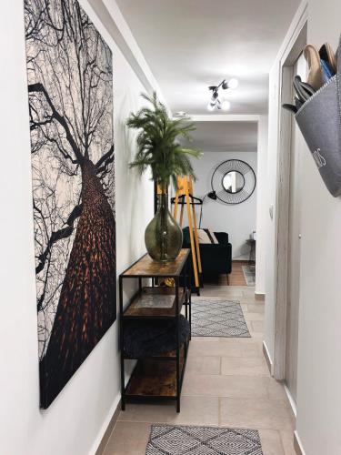 a hallway with a painting of a tree on the wall at Middle of the city apartmann in Pécs