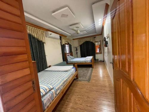 a bedroom with two beds in a room at Eagles Nest Muzaffarabad in Muzaffarabad