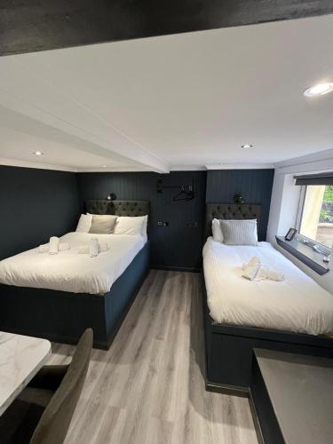a bedroom with two beds and a window at Sutherland mini apartments in Fort William