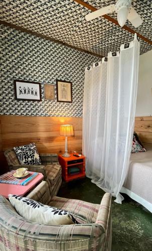 a living room with a bed and a couch at Hospedaria Santa Bárbara in Rio de Janeiro
