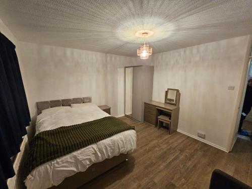 a bedroom with a bed and a desk in it at Your Cozy Home Away From Home in Surbiton