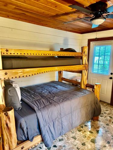 a bedroom with a bunk bed in a cabin at Cedar Wood Lodge Wkayaks & Canoes, Outdoor Dining in Karnack