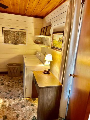 a room with a desk with a lamp on it at Cedar Wood Lodge Wkayaks & Canoes, Outdoor Dining in Karnack