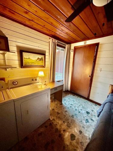 a room with a desk with a lamp in it at Cedar Wood Lodge Wkayaks & Canoes, Outdoor Dining in Karnack