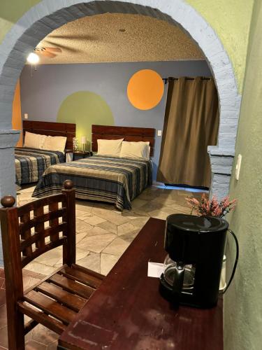 1 dormitorio con 2 camas y mesa con cafetera en Hotel Camino de Allende, en San Miguel de Allende